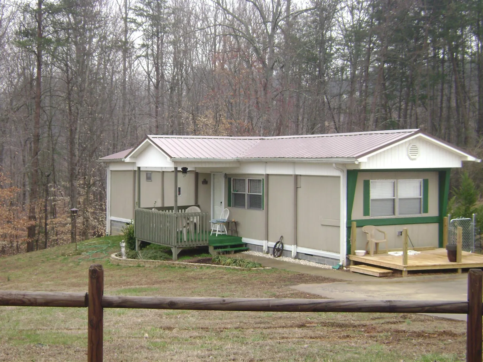 Mauve metal roof on a manufactured home with a new front deck in Bristol